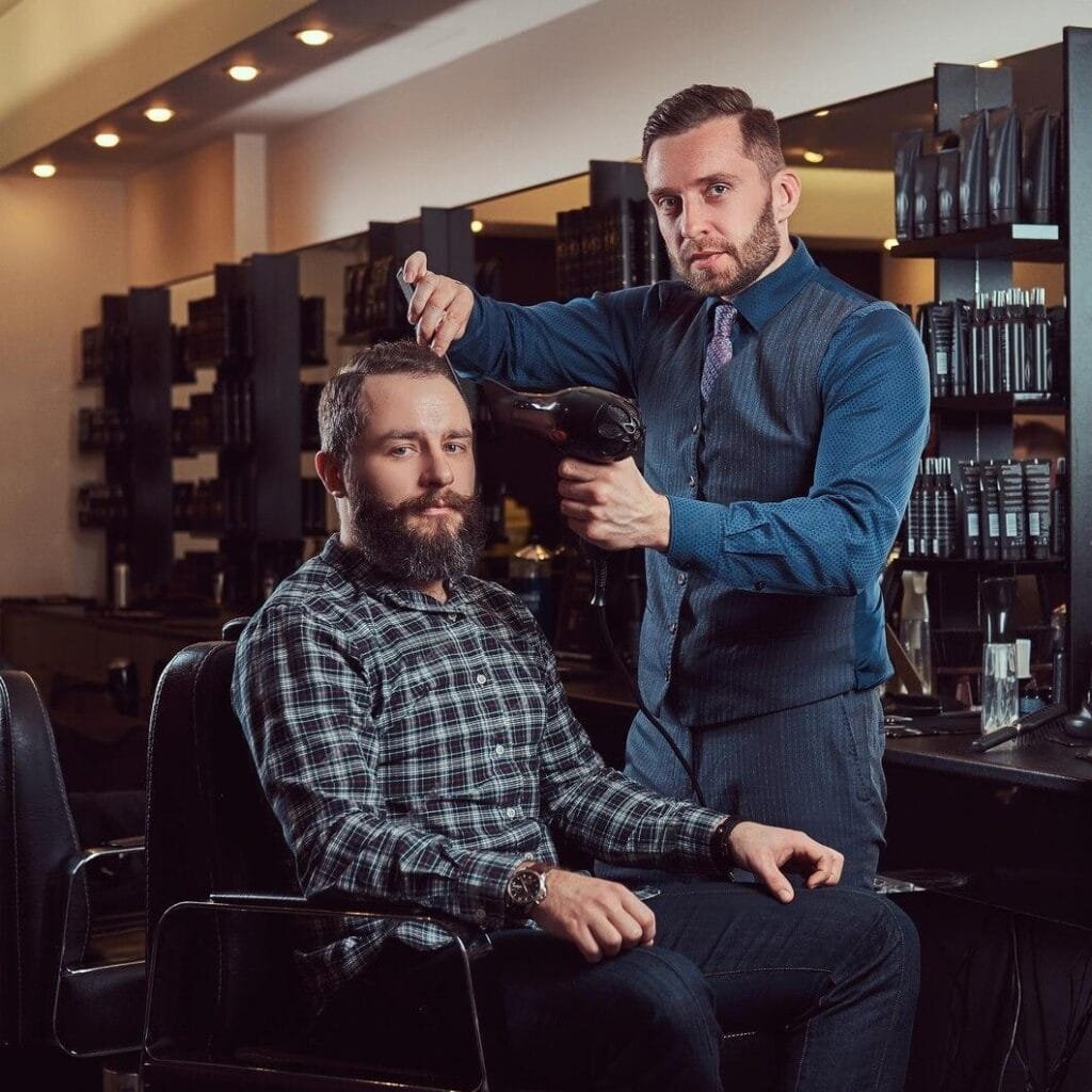 professional-barber-working-with-client-hairdressing-salon-uses-hair-dryer-men-s-haircut-barbershop_613910-5052-transformed